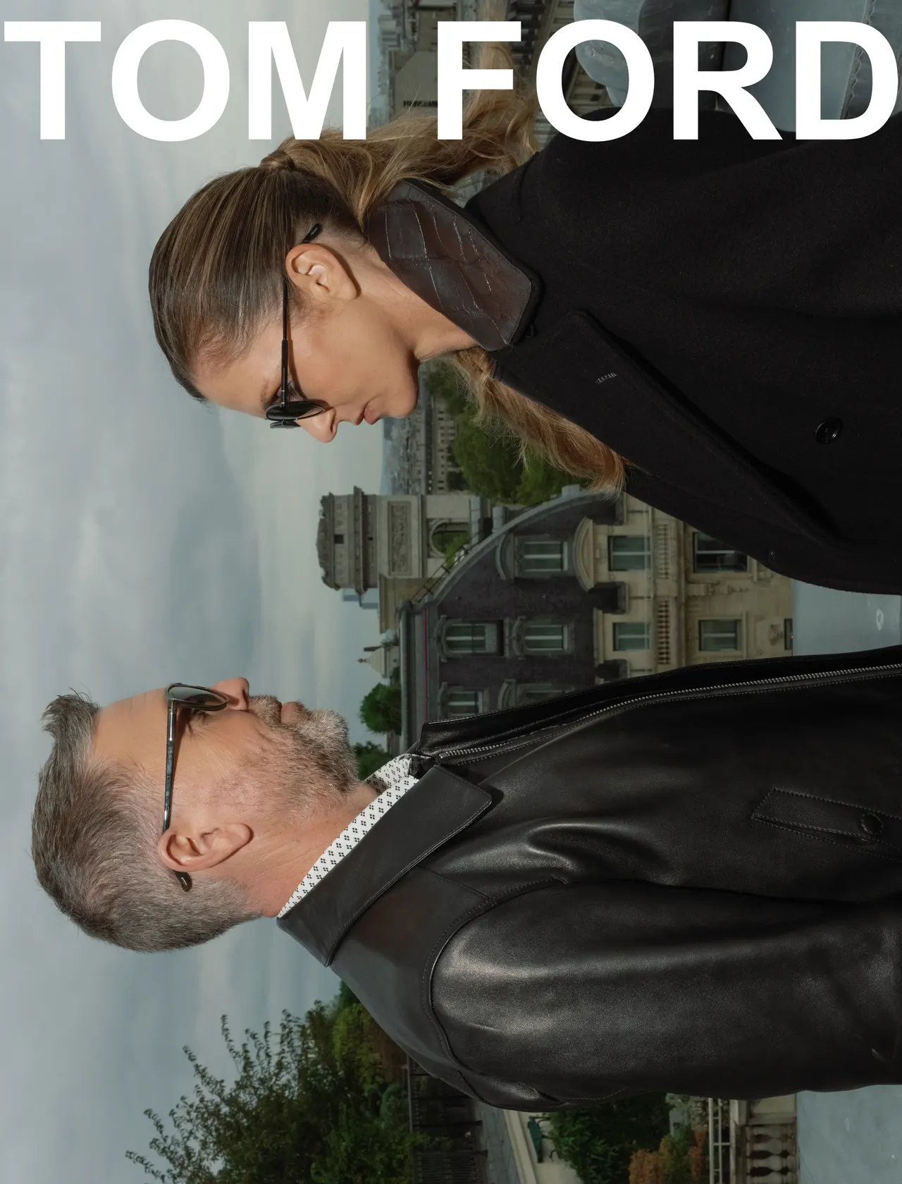Couple dressed in Tom Ford on a Paris rooftop, with Tom Ford lettering