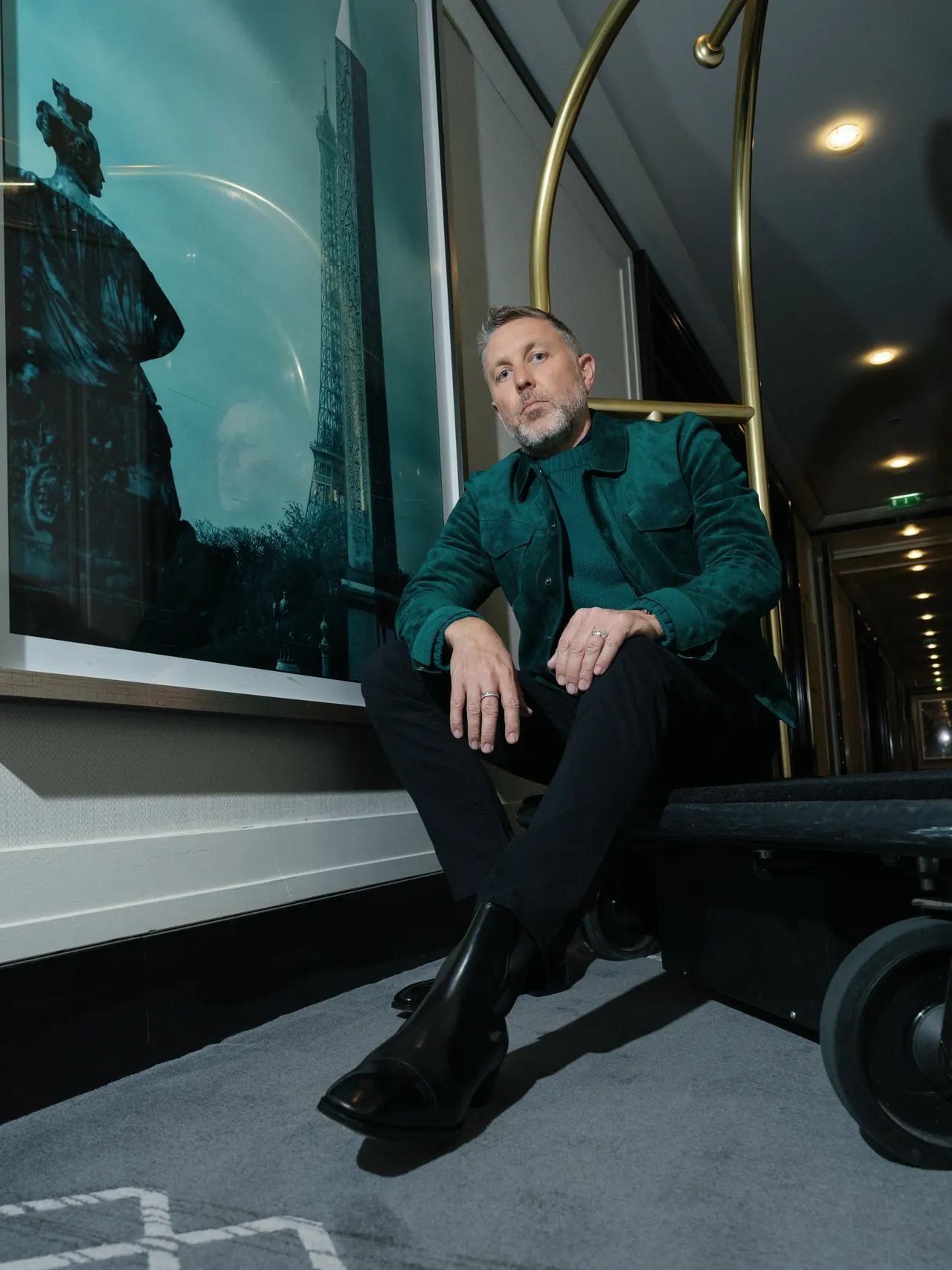 Portrait in a green Tom Ford jacket in a corridor at The Peninsula Paris