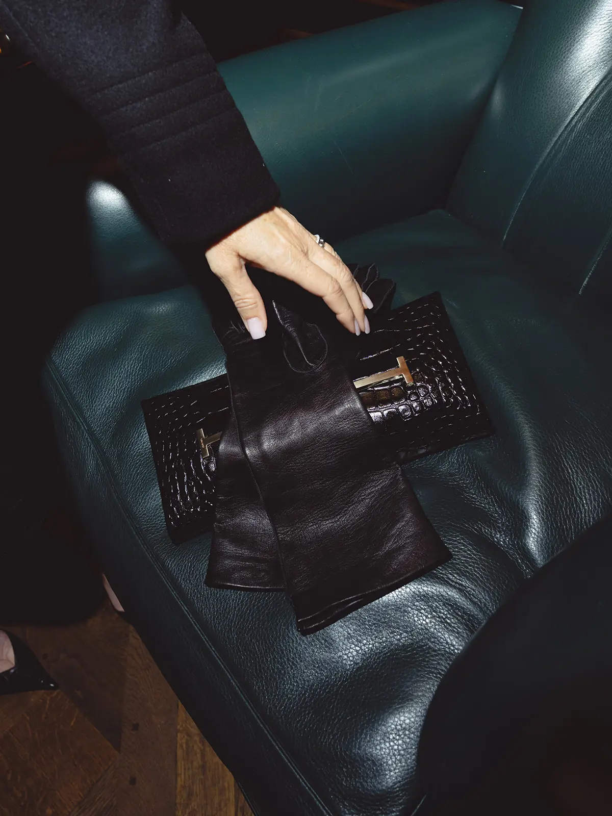 Tom Ford accessories on a green leather armchair
