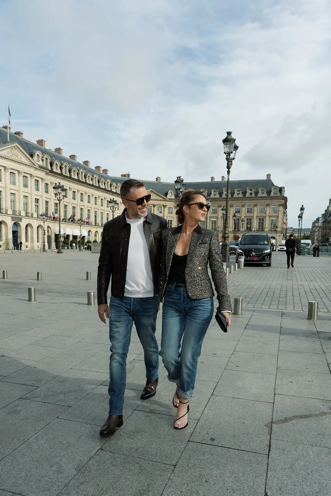 Couple walking closely together on Place Vendôme