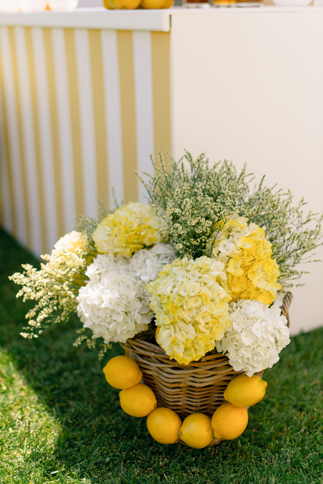 Yellow and white floral styling with lemons at a Provence pool party