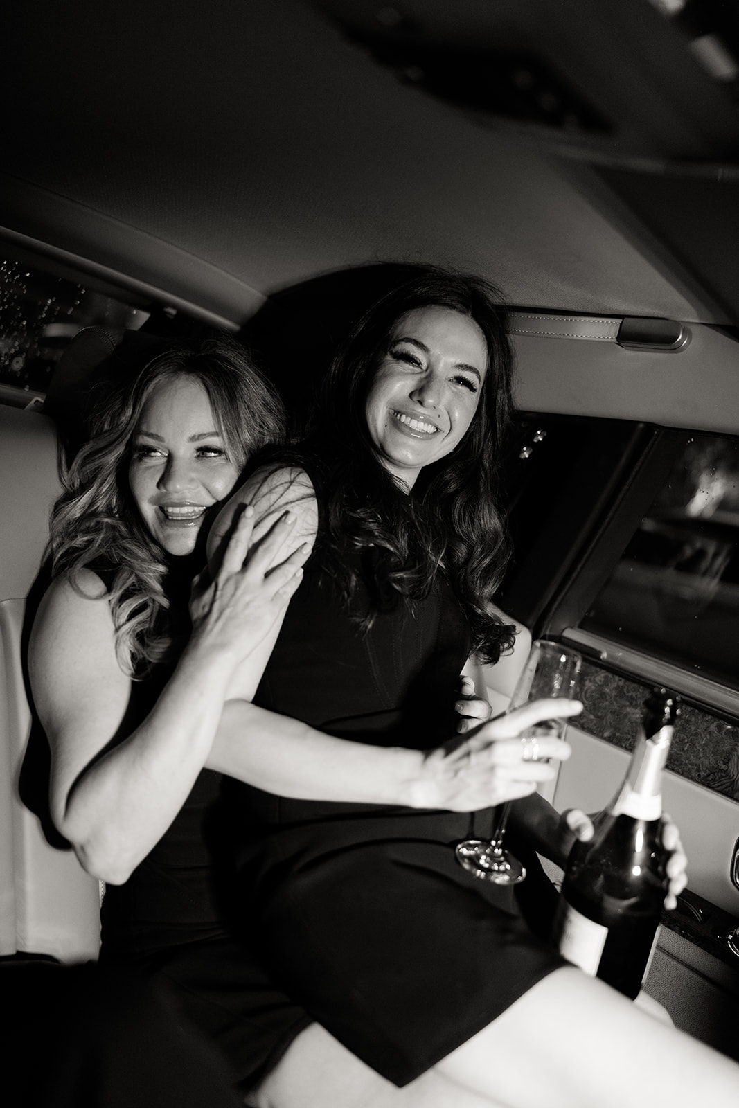Couple sharing champagne during an evening car ride through Paris