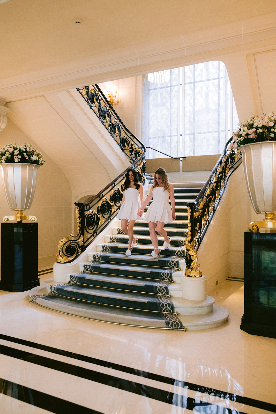 Couple descending the grand staircase during an elopement at The Peninsula Paris