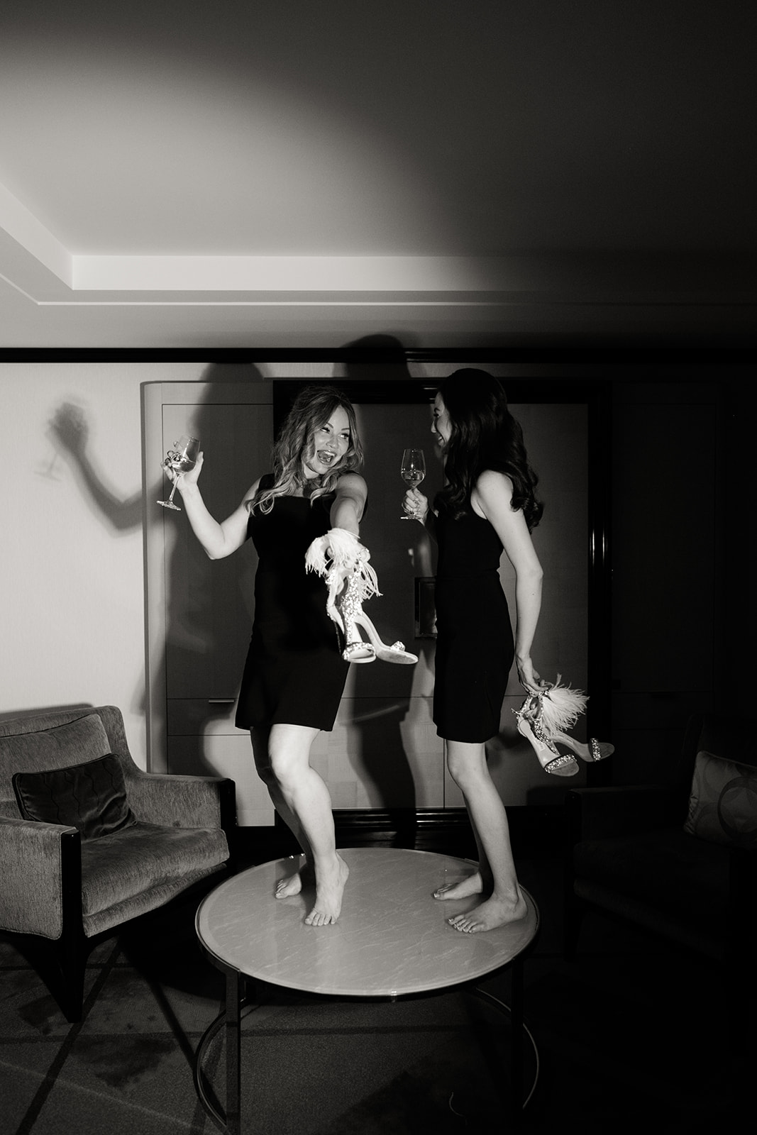 Couple celebrating in black dresses during an editorial Peninsula Paris elopement