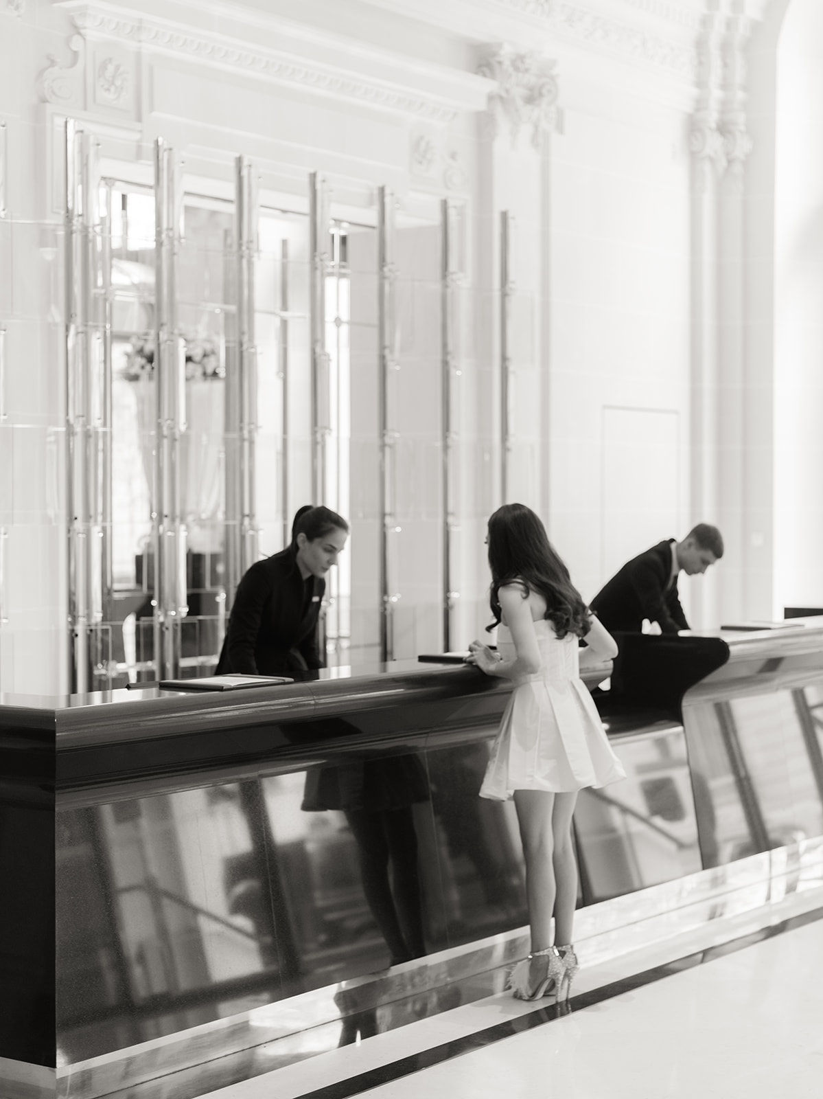 Editorial elopement portrait beside the reception desk at The Peninsula Paris
