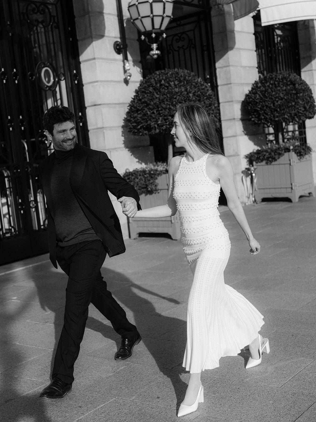 Editorial couple walking outside the Ritz Paris during a fashion-inspired Paris photoshoot