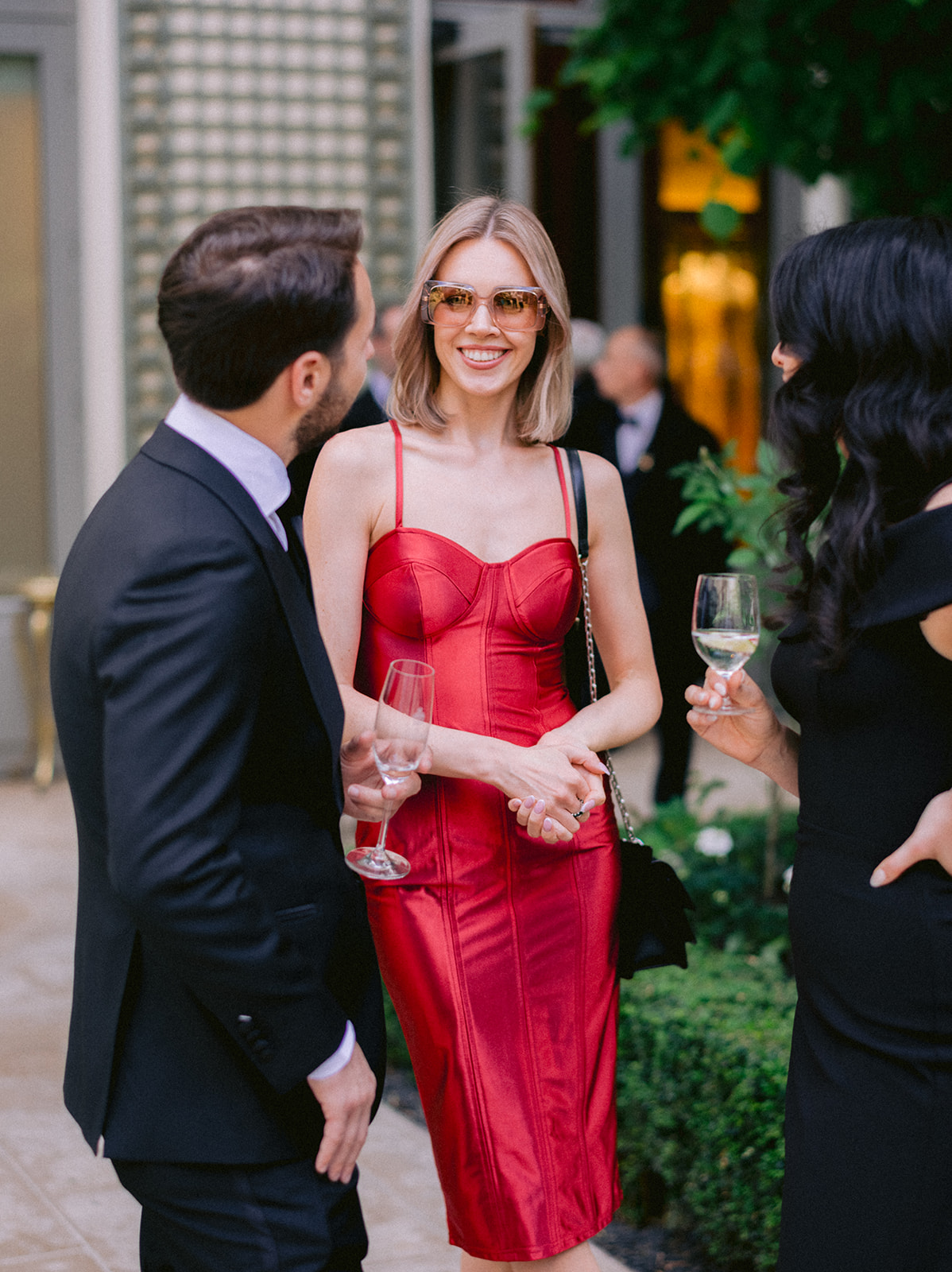 Wedding guest in a red evening dress during a luxury Paris cocktail reception