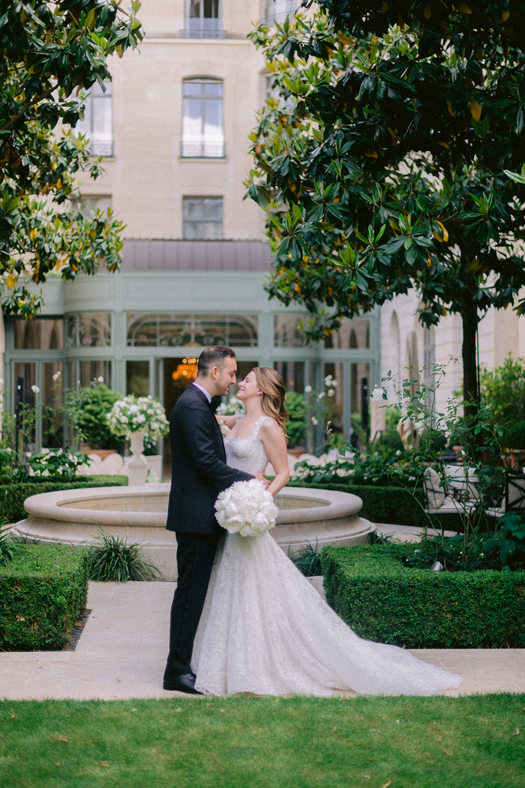 Romantic newlywed portrait in a landscaped garden at a Paris wedding venue