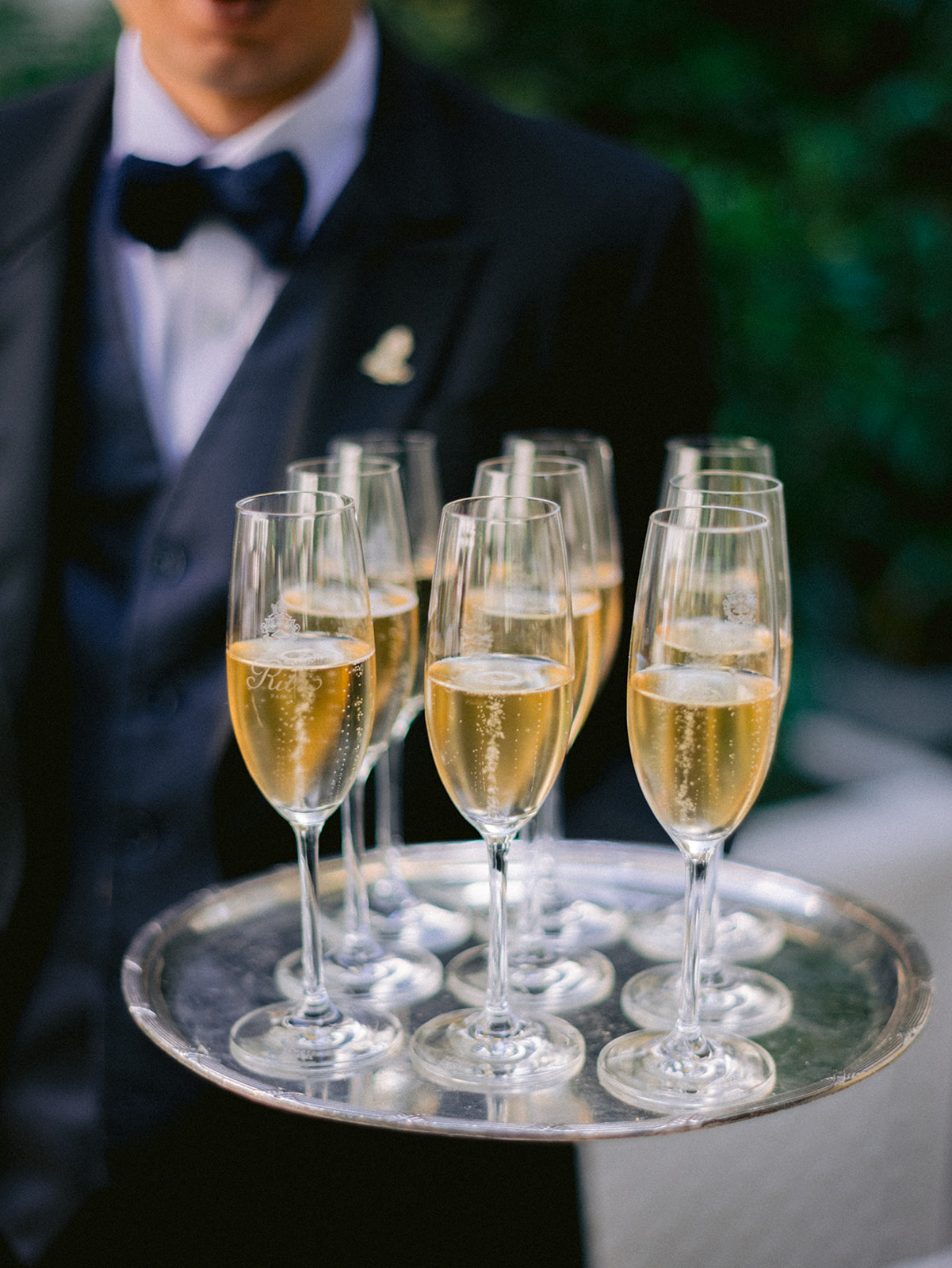 Champagne service presented during a luxury wedding cocktail in Paris