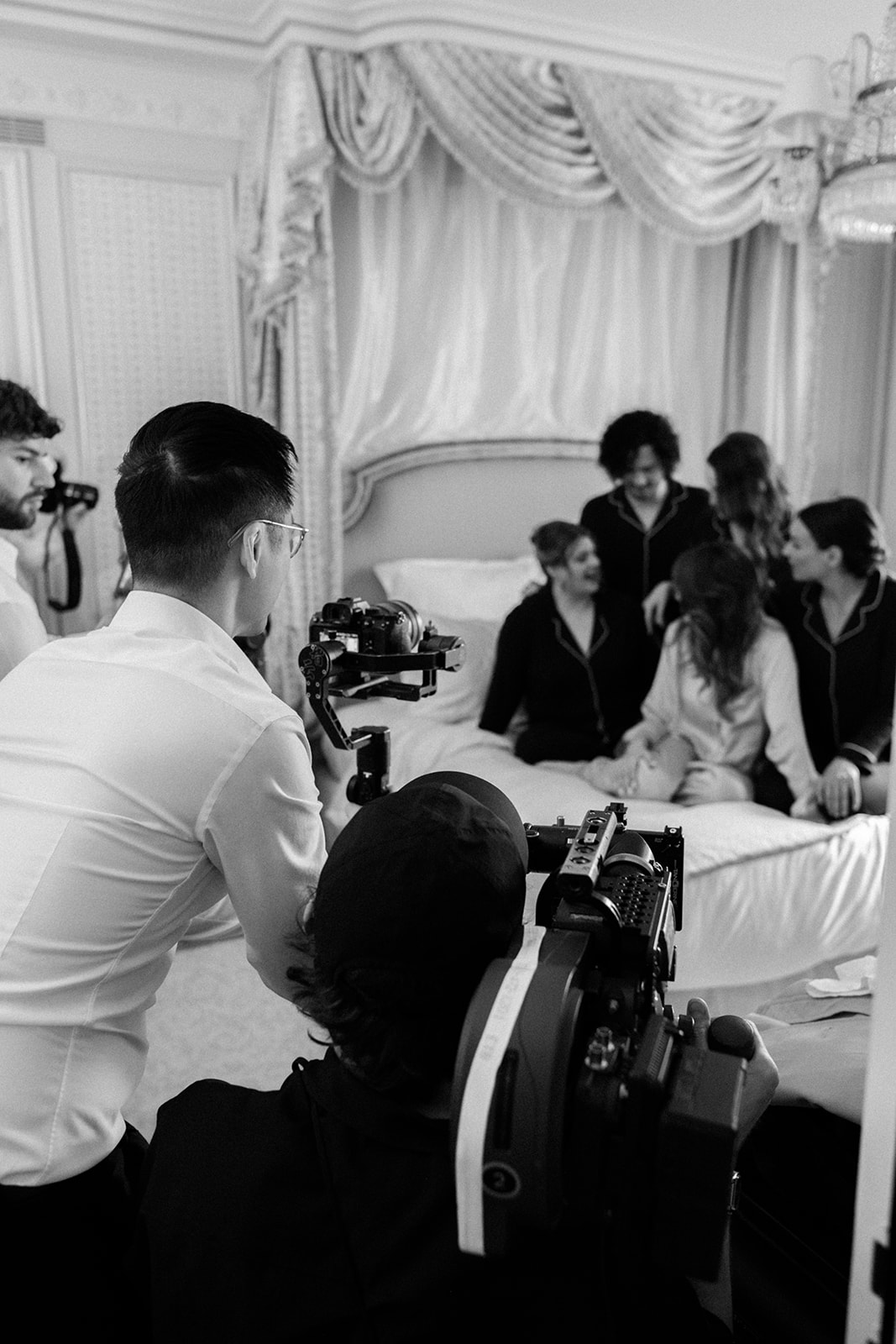 Wedding film crew documenting bridal preparation in a luxury Paris hotel suite
