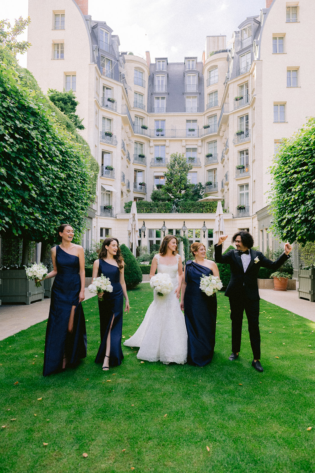 Bride walking through the garden with her wedding party