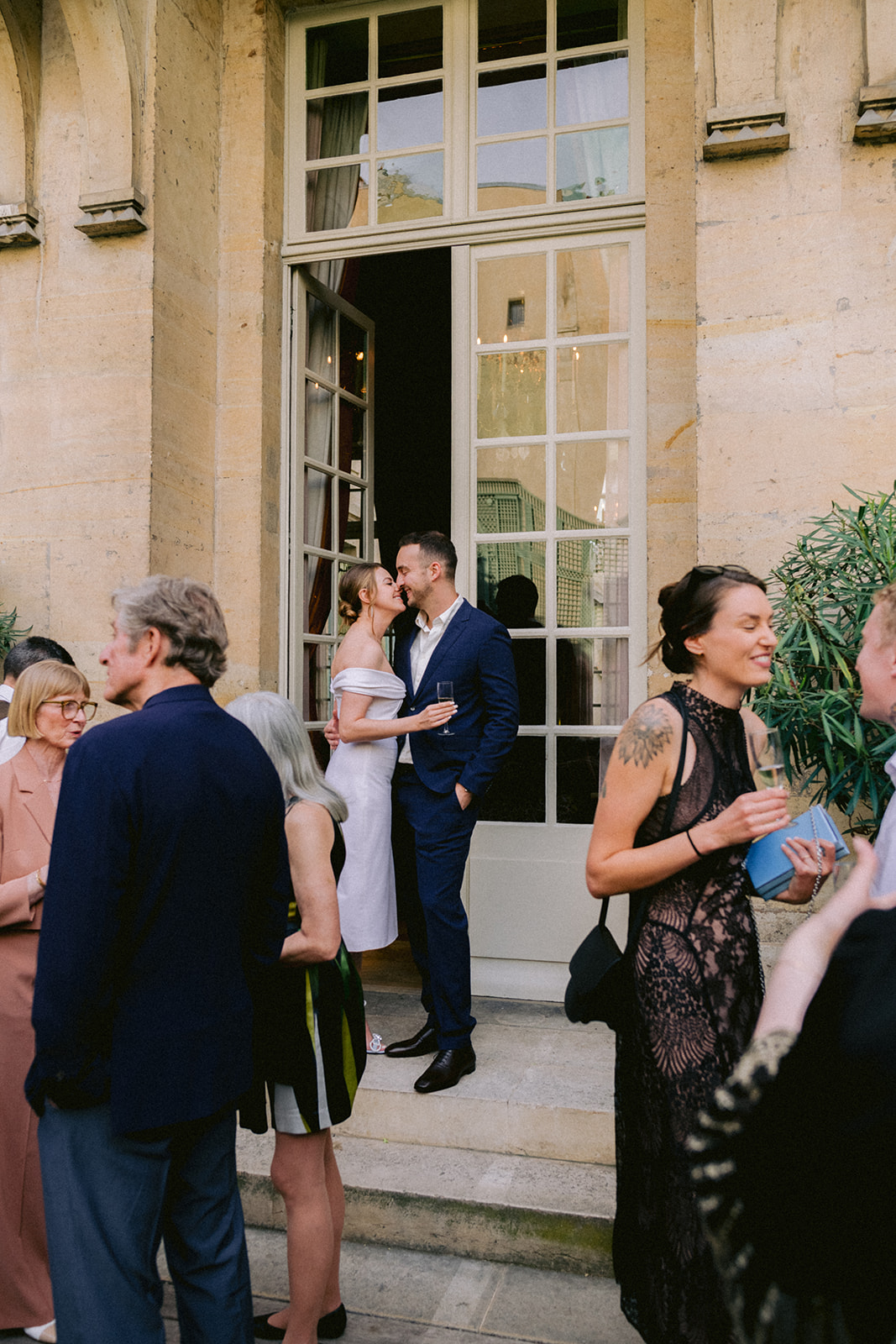 Couple sharing a candid moment with guests at a Paris welcome dinner