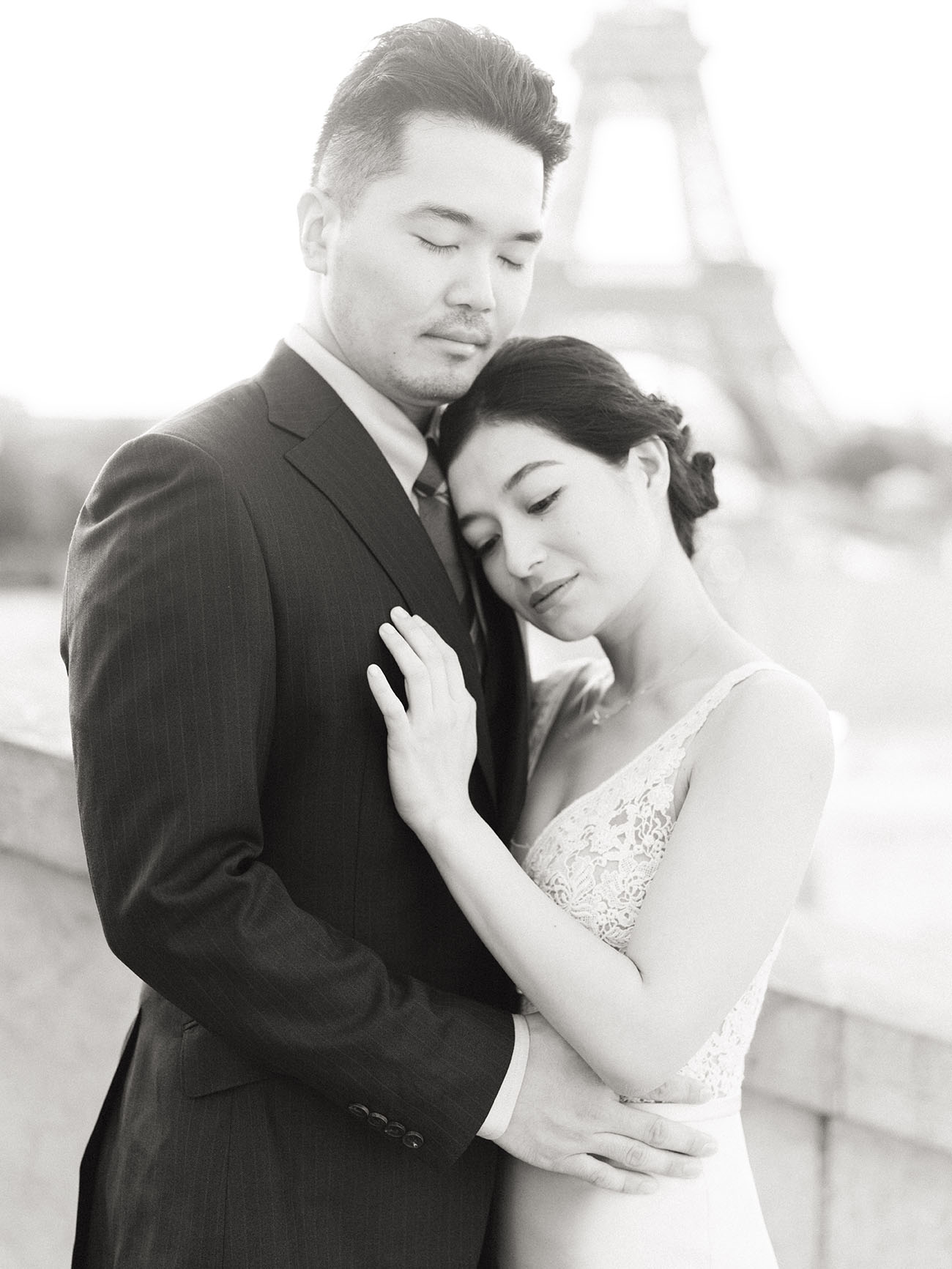 Couple cuddling at the Eiffel Tower in Paris