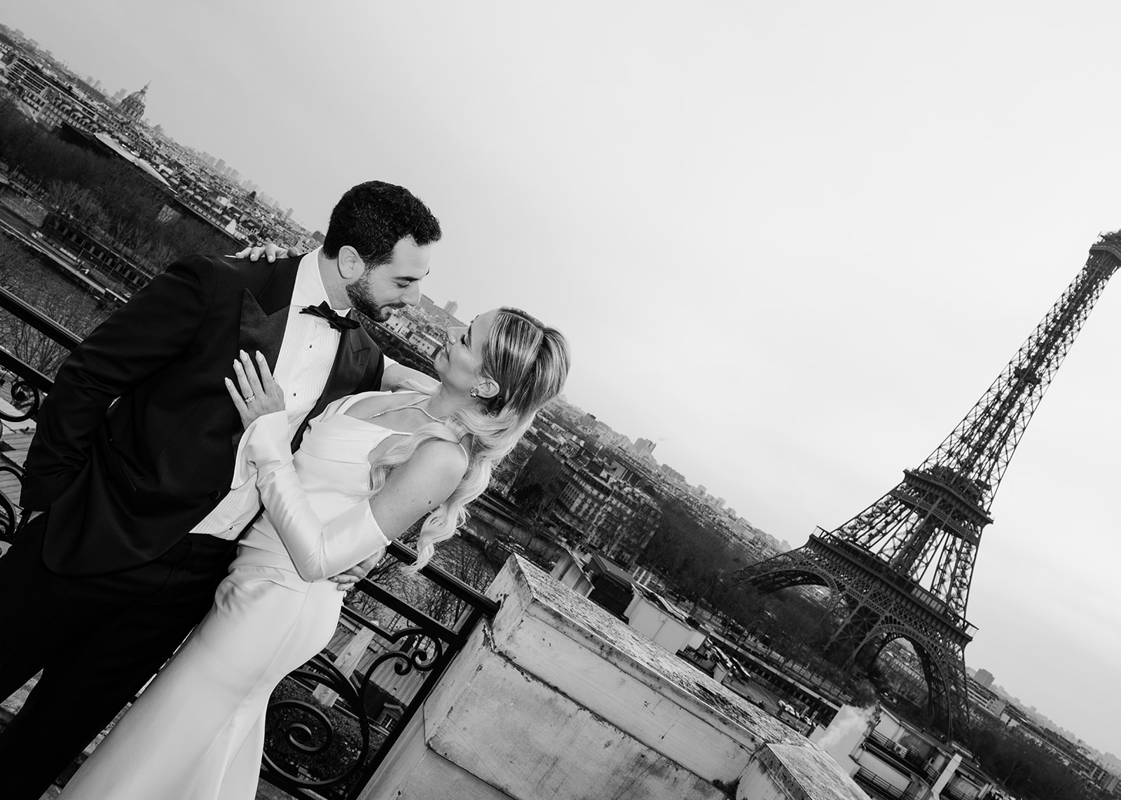 Wedding couple overlooking the Eiffel Tower while choosing a Paris wedding venue