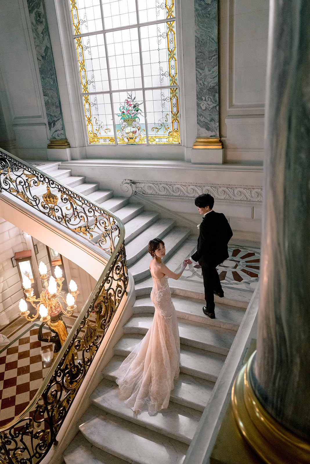 Wedding couple on the historic grand staircase at Shangri-La Paris