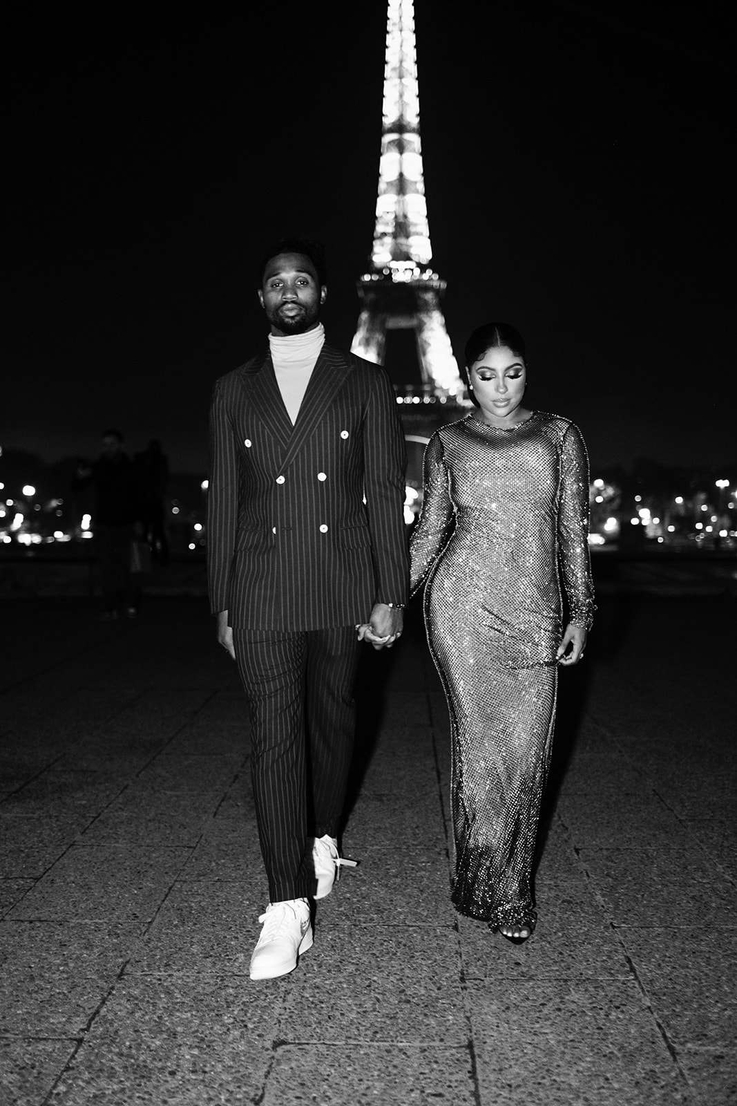 Candice Craig and Omar Bolden walking side by side during their Paris night portrait session