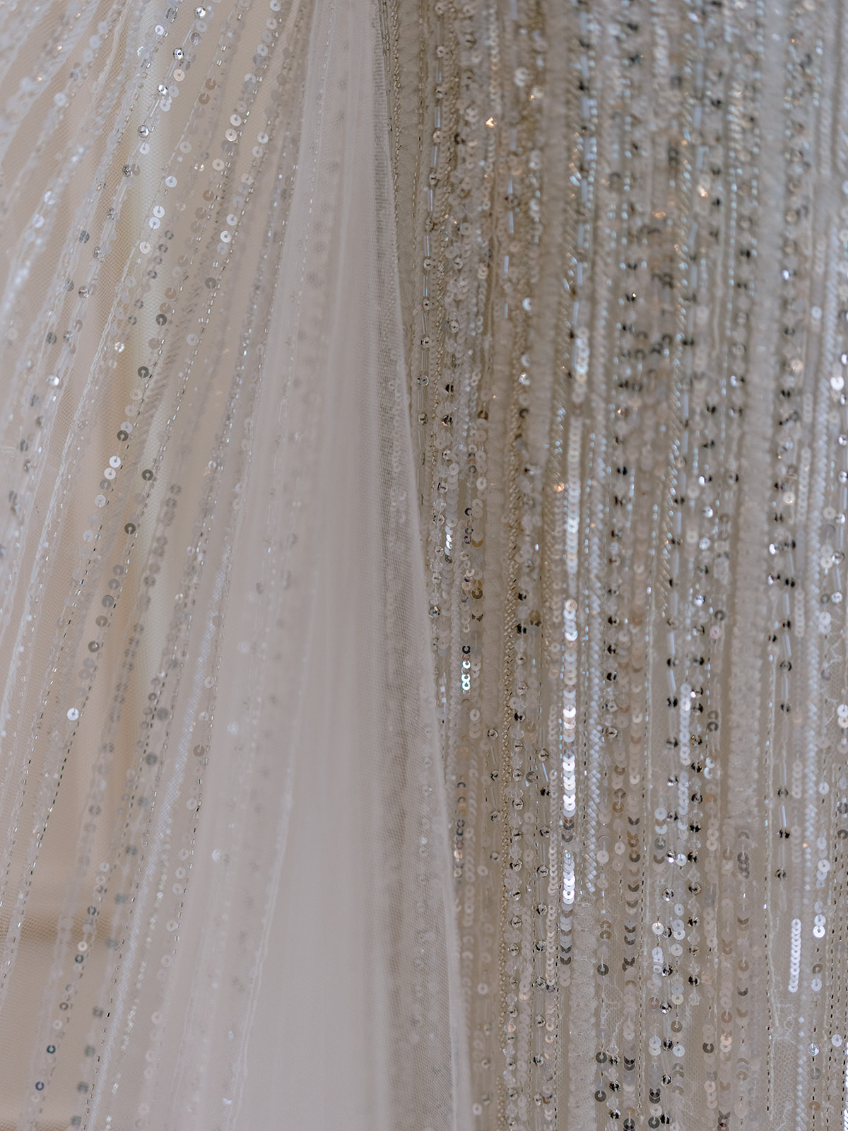 Close-up of crystal beading and sequins on a couture wedding dress in Paris