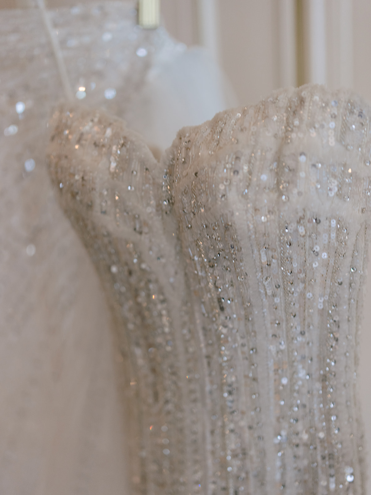 Close-up of the beaded corset bodice of a couture wedding dress in Paris