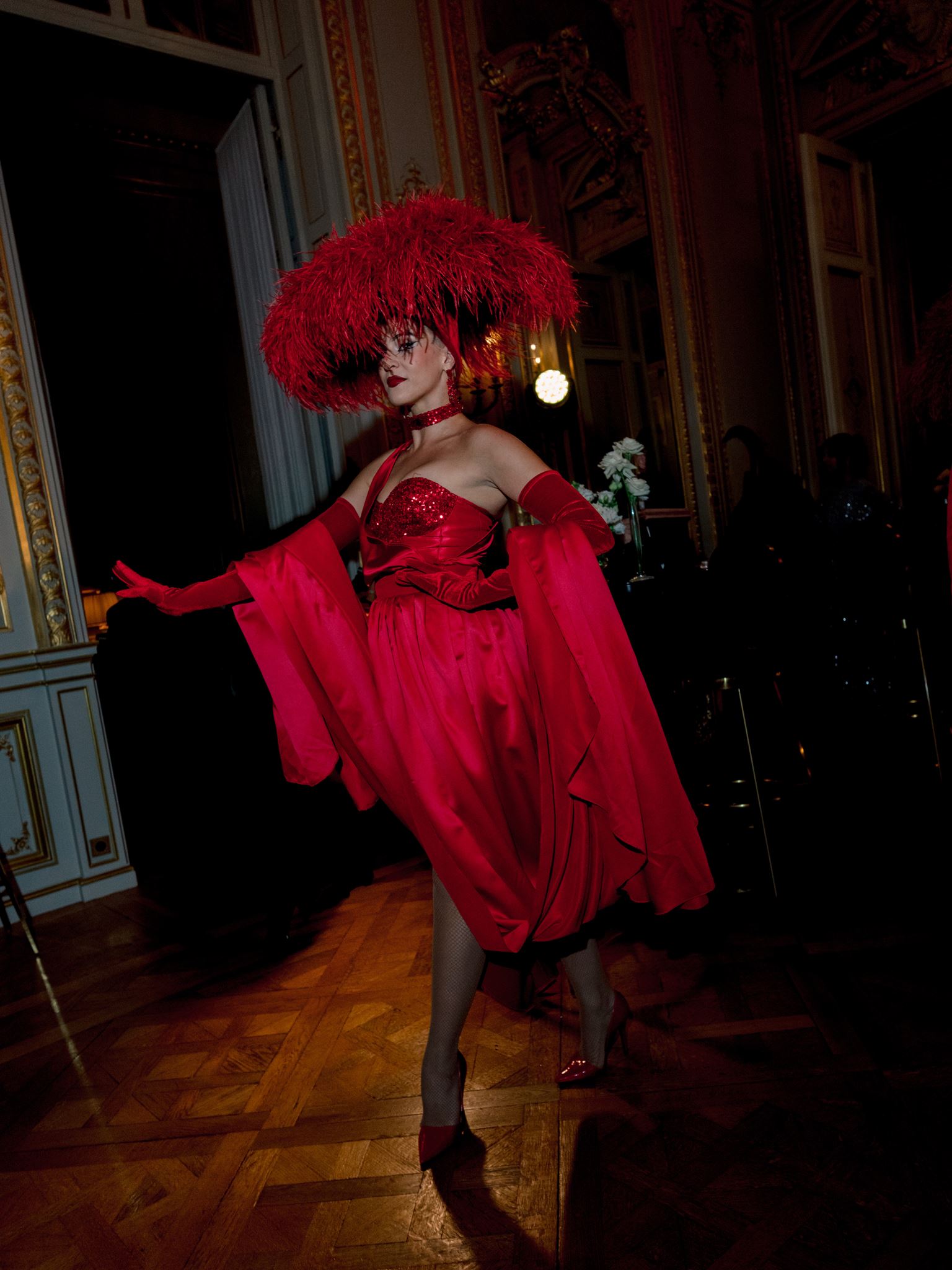 Performer in red with a floral headpiece at an editorial Paris wedding reception