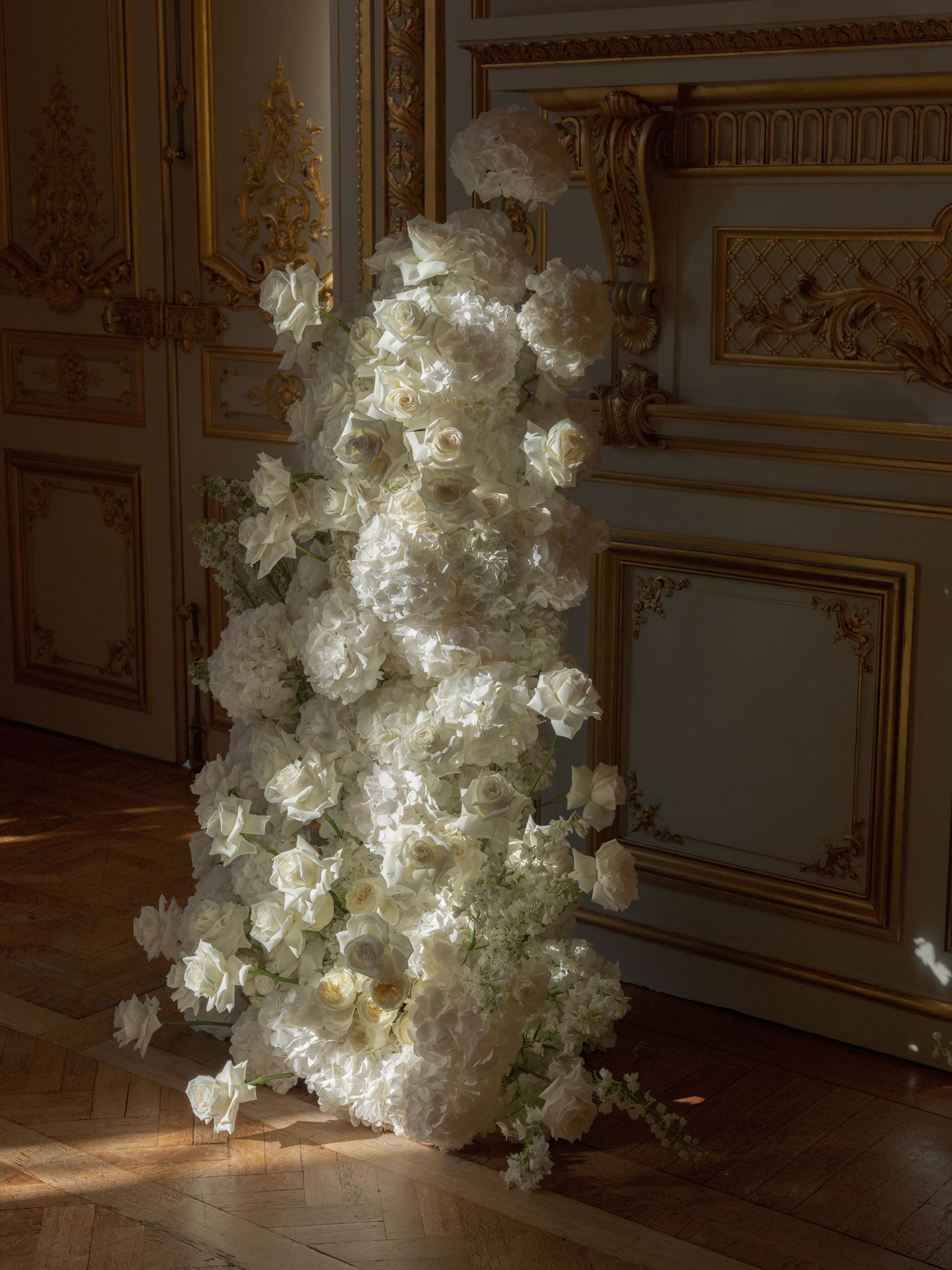 Sculptural white floral installation inside a luxury Paris wedding venue