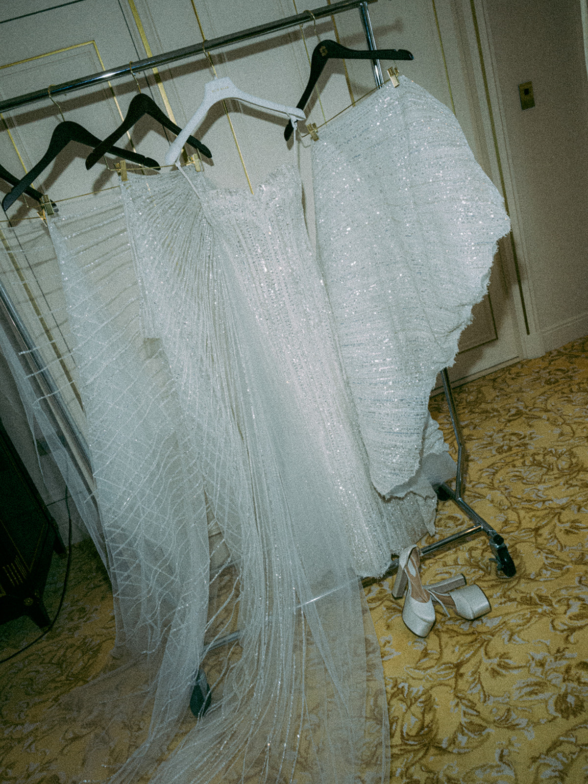 Embellished wedding dresses and bridal shoes prepared before a Paris wedding