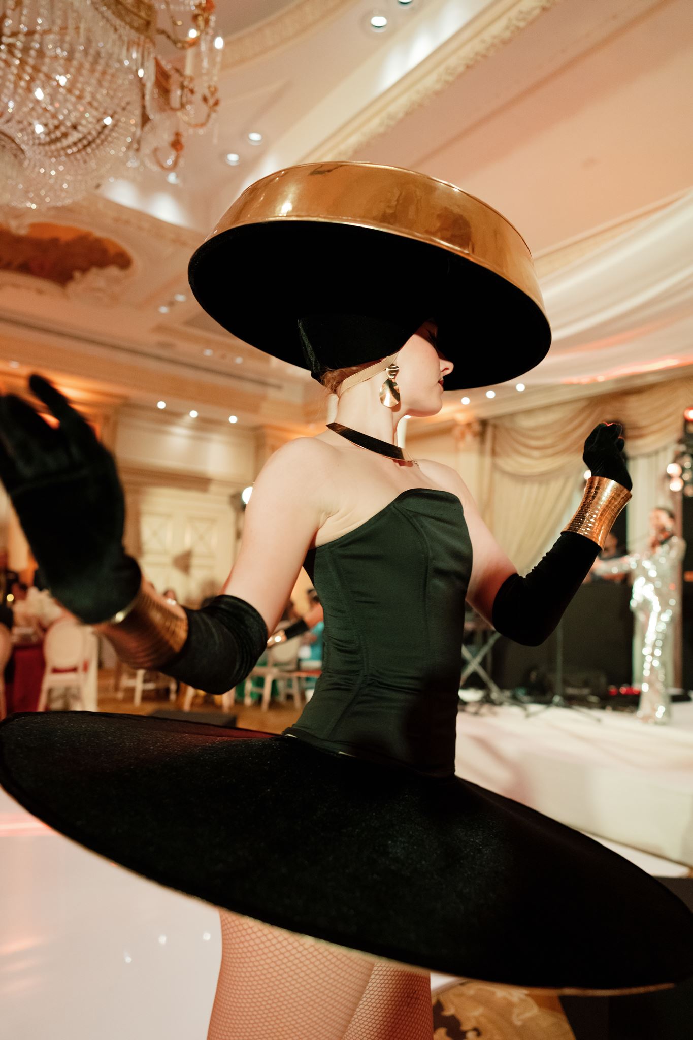 Performer in a sculptural black hat during the Shangri-La Paris wedding reception