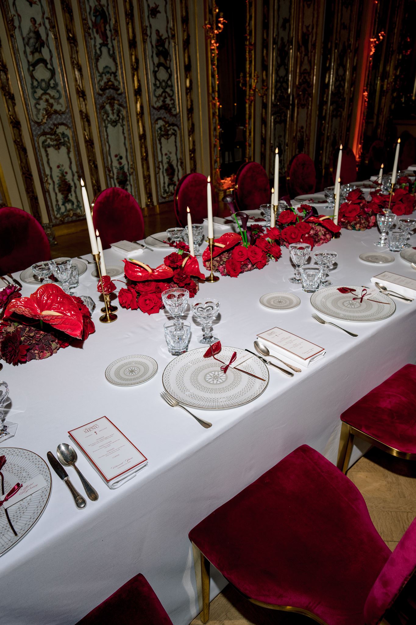 Long red floral dinner table in the historic salons at Shangri-La Paris
