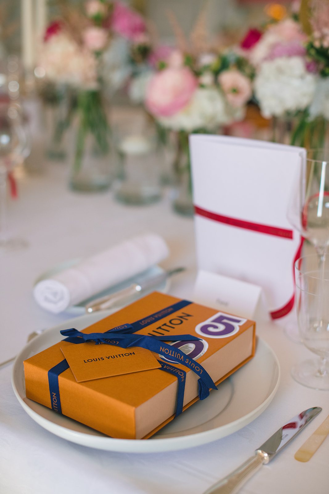 Louis Vuitton gift box placed on a floral birthday table at Hôtel Plaza Athénée Paris
