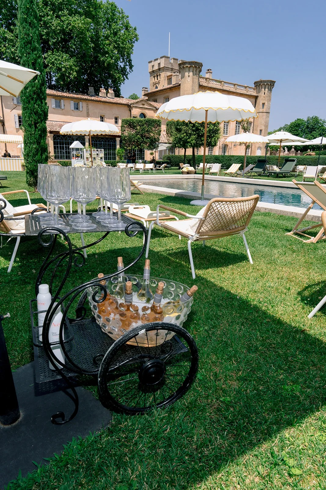 Champagne service beside a pool at a private wedding estate in Provence