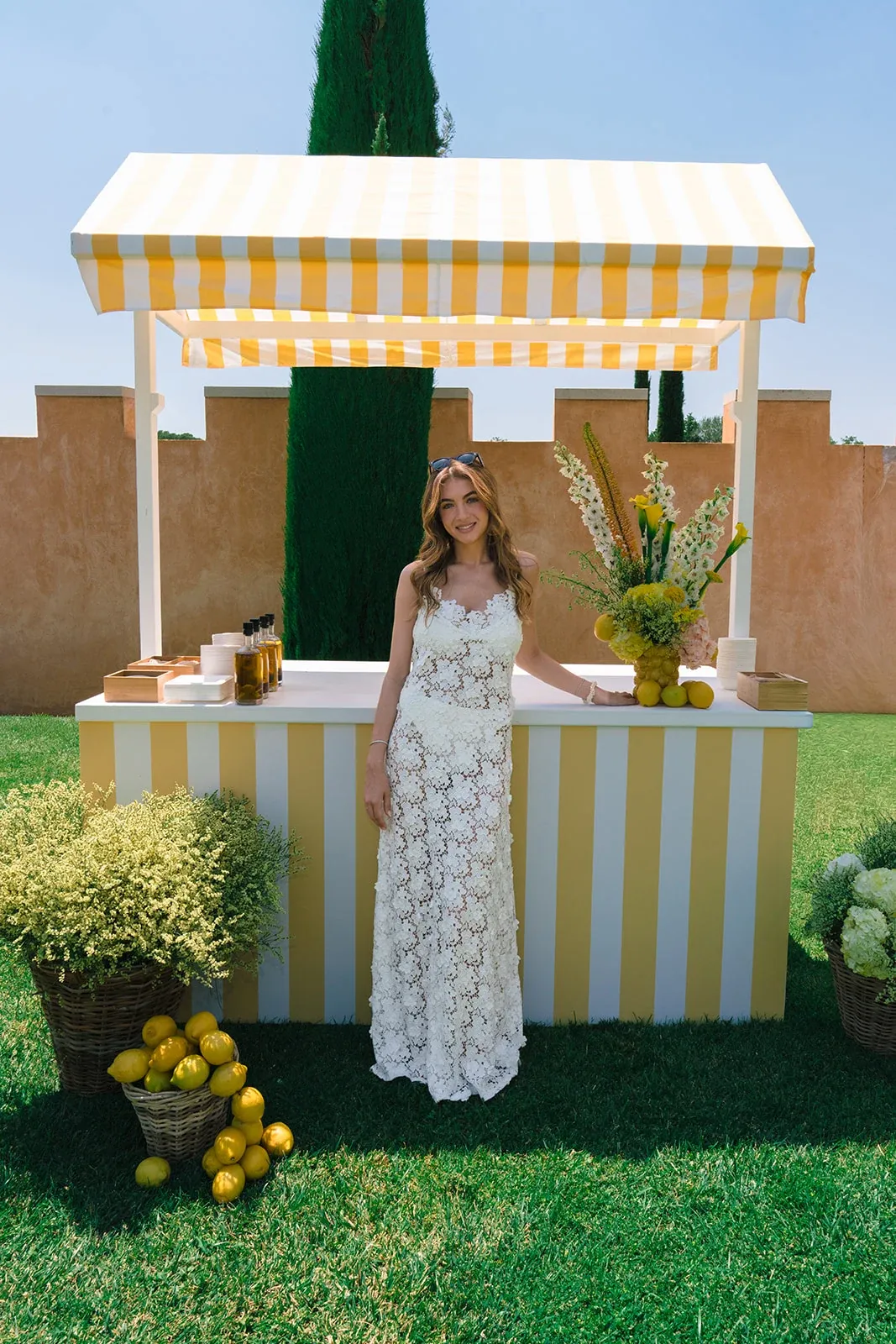 Bride at the lemonade bar during the Villa Baulieu pool party