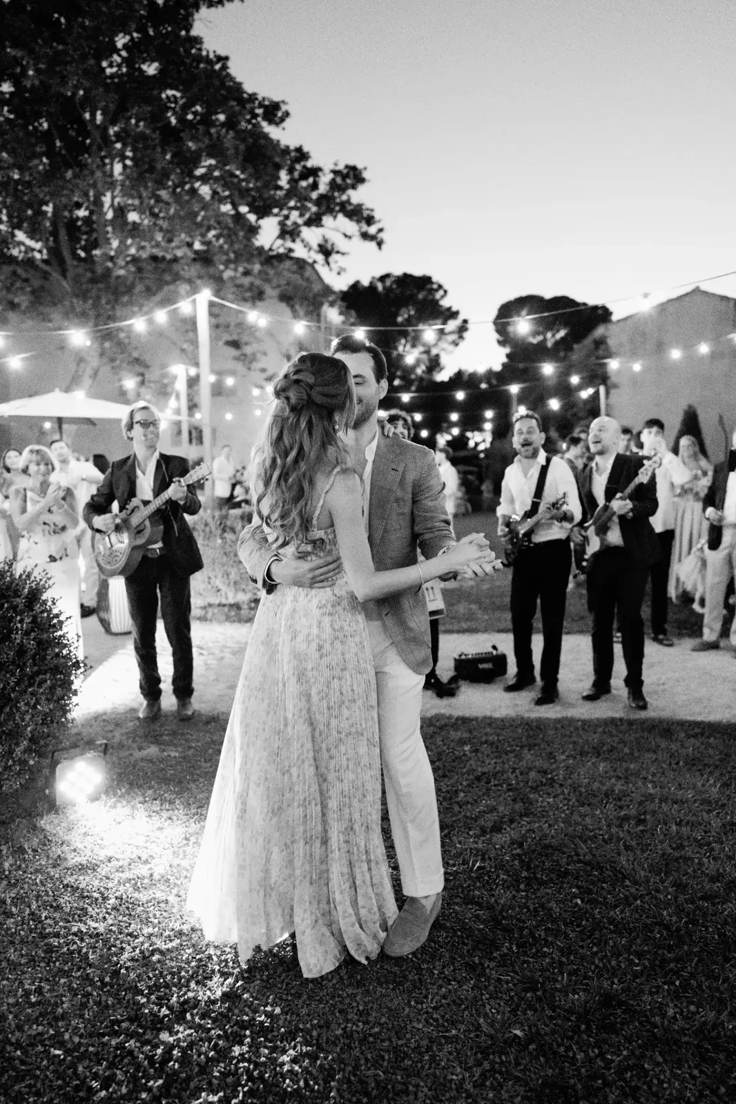 Couple dancing under string lights during the Day 2 welcome dinner at Château de la Gaude