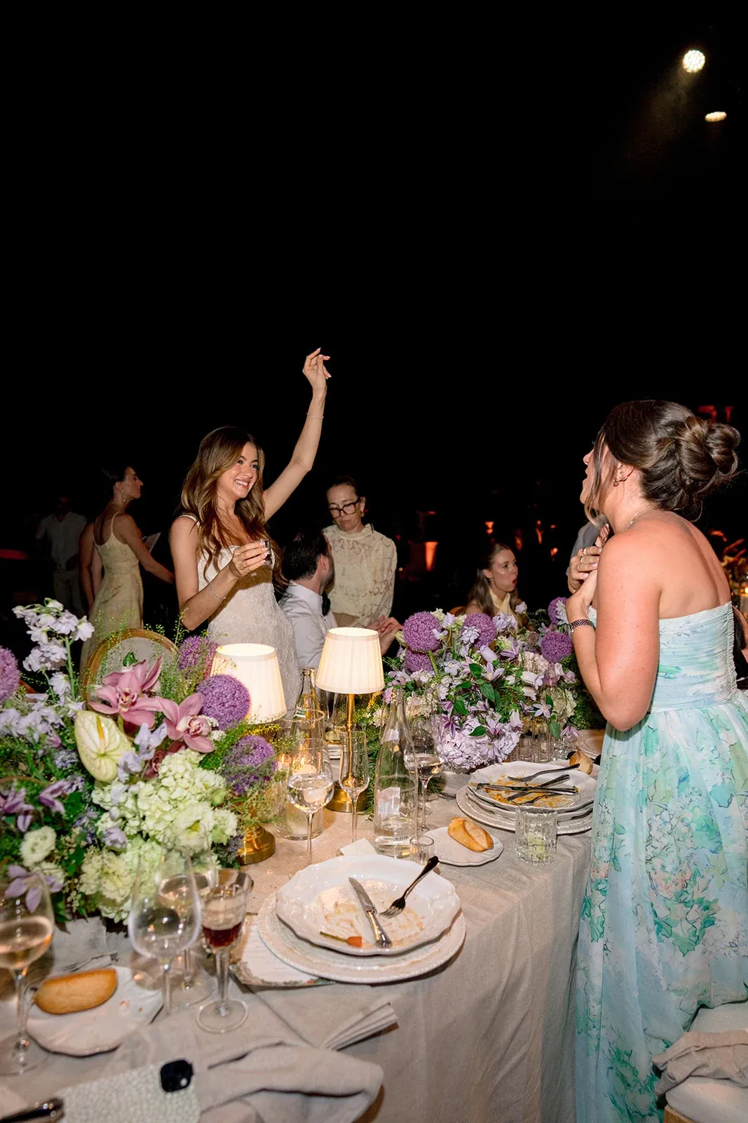 Bride raising her hand during the dinner reception at Villa Baulieu