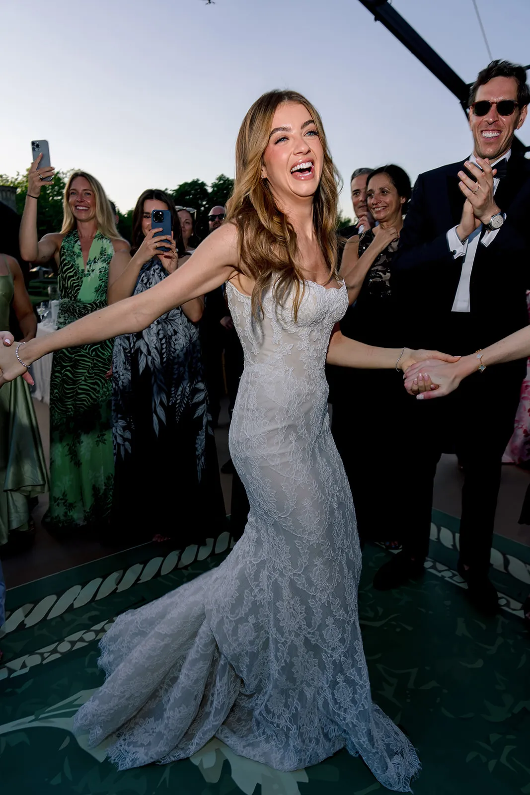 Bride laughing and dancing with guests during the Villa Baulieu wedding reception