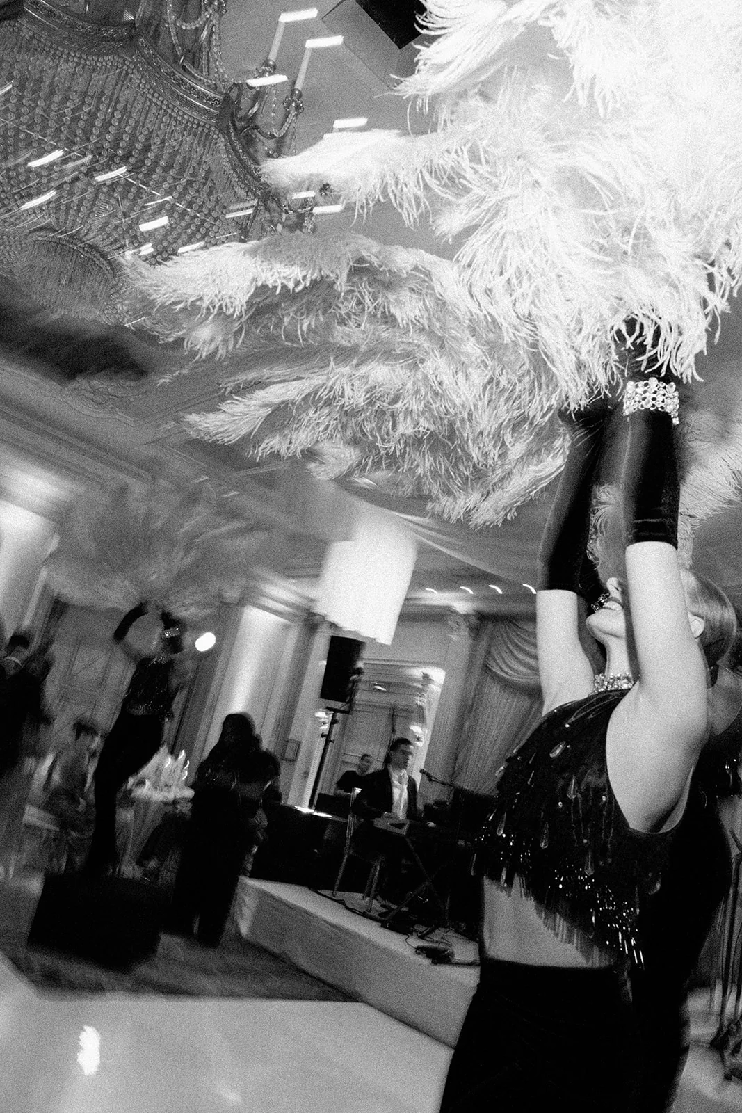 Guest celebrating beneath a feather decoration at a wedding party in Shangri-La Paris