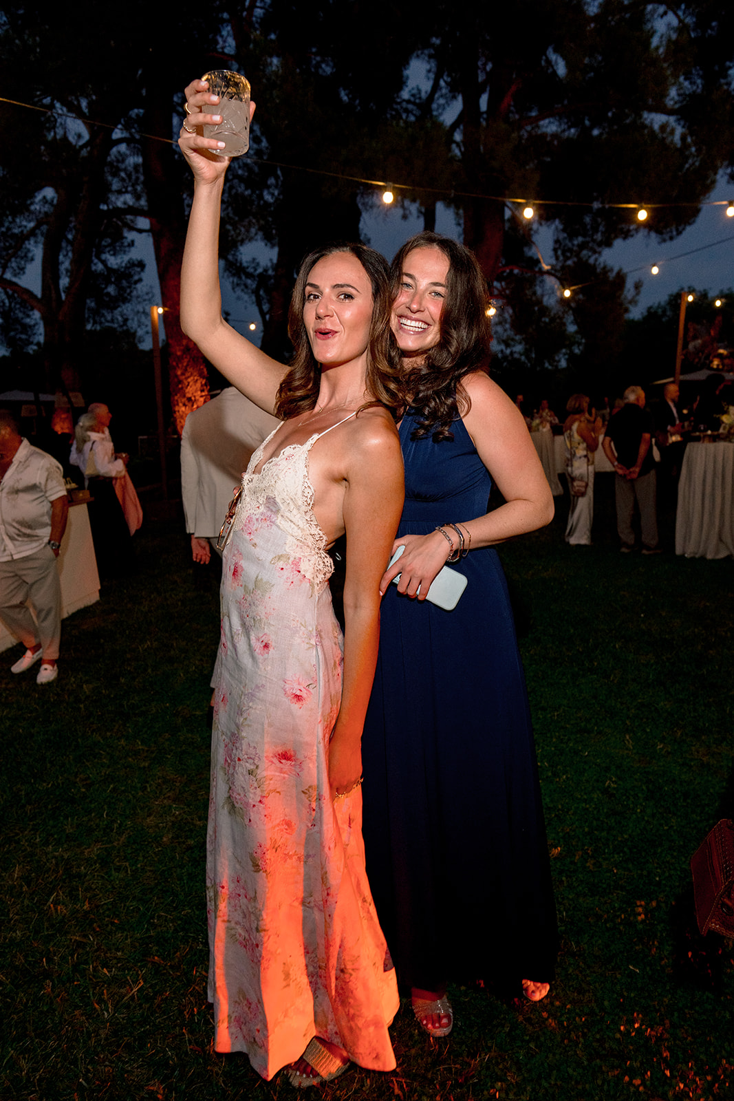 Wedding guests raising a toast at the Villa Baulieu welcome party