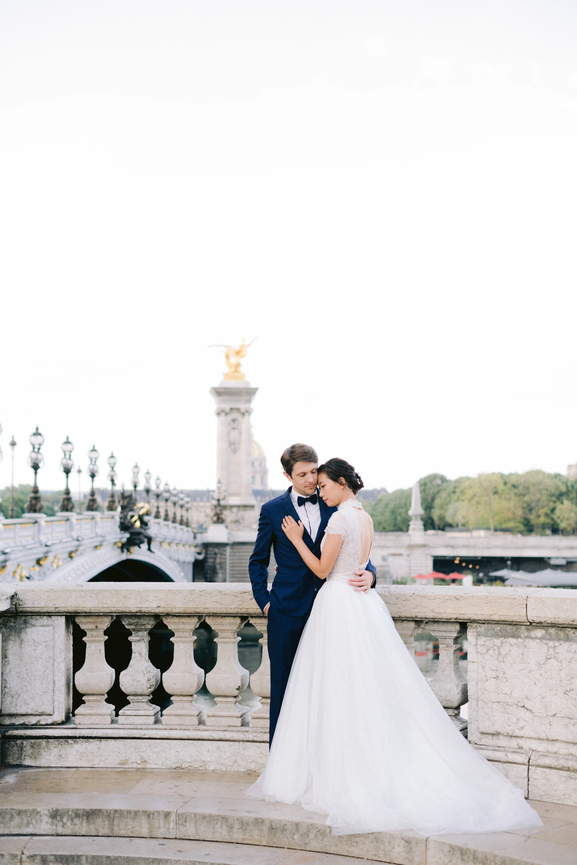 Couple walking on Pont Alexandre III during a pre-wedding session