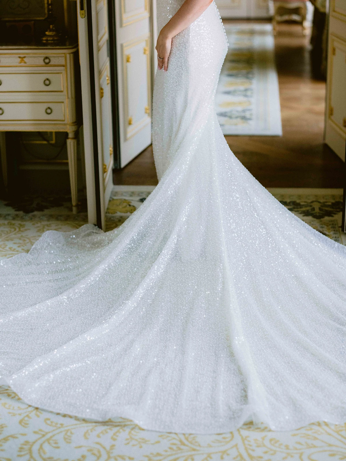 Close view of a sparkling couture wedding gown and train at The Ritz Paris
