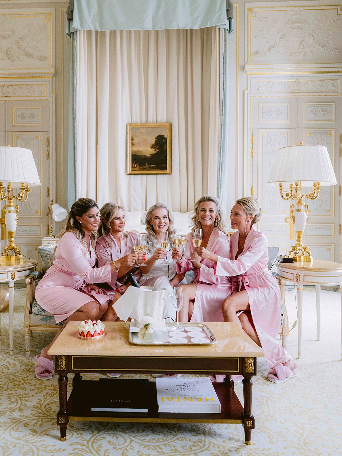 Bride and bridesmaids sharing a champagne toast inside The Ritz Paris