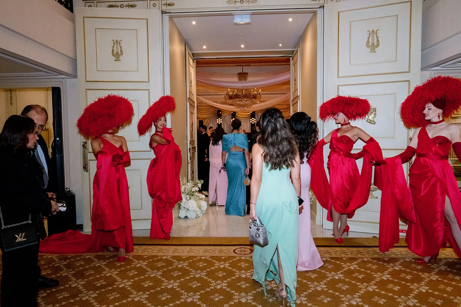 Red-costumed entertainers welcoming guests at a Shangri-La Paris wedding entrance