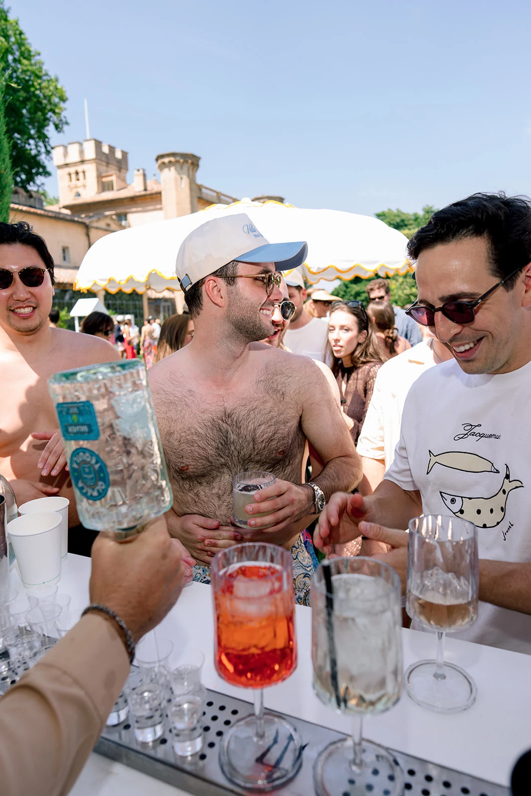 American wedding guests ordering cocktails during a pool party in Provence