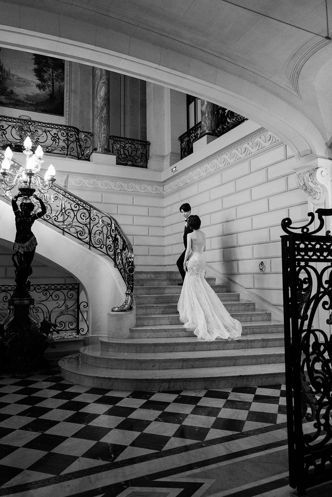 Couple standing together on the grand staircase at Shangri-La Paris