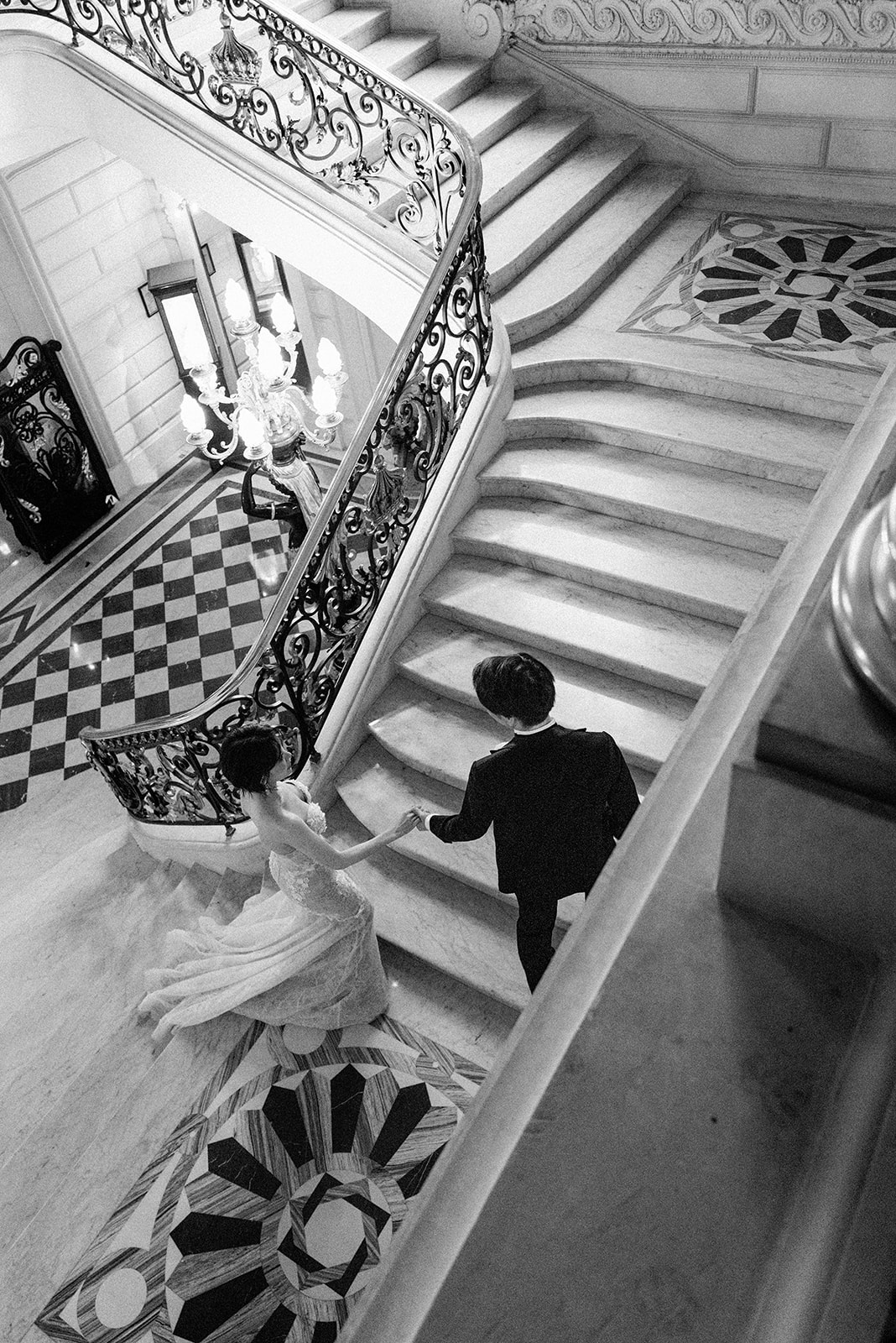 Overhead view of a couple descending the staircase at Shangri-La Paris