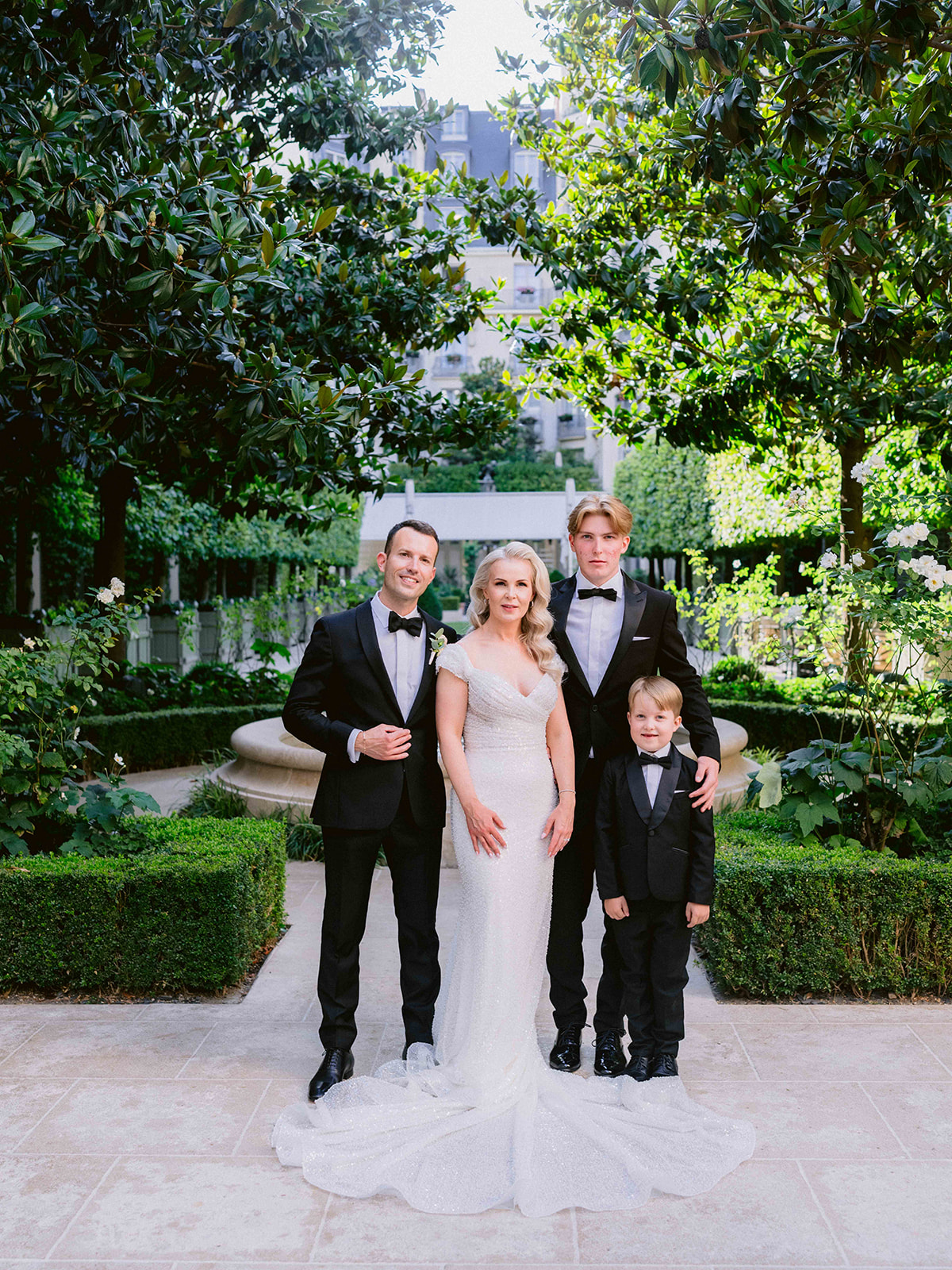 Family portrait in the garden courtyard during a wedding at The Ritz Paris