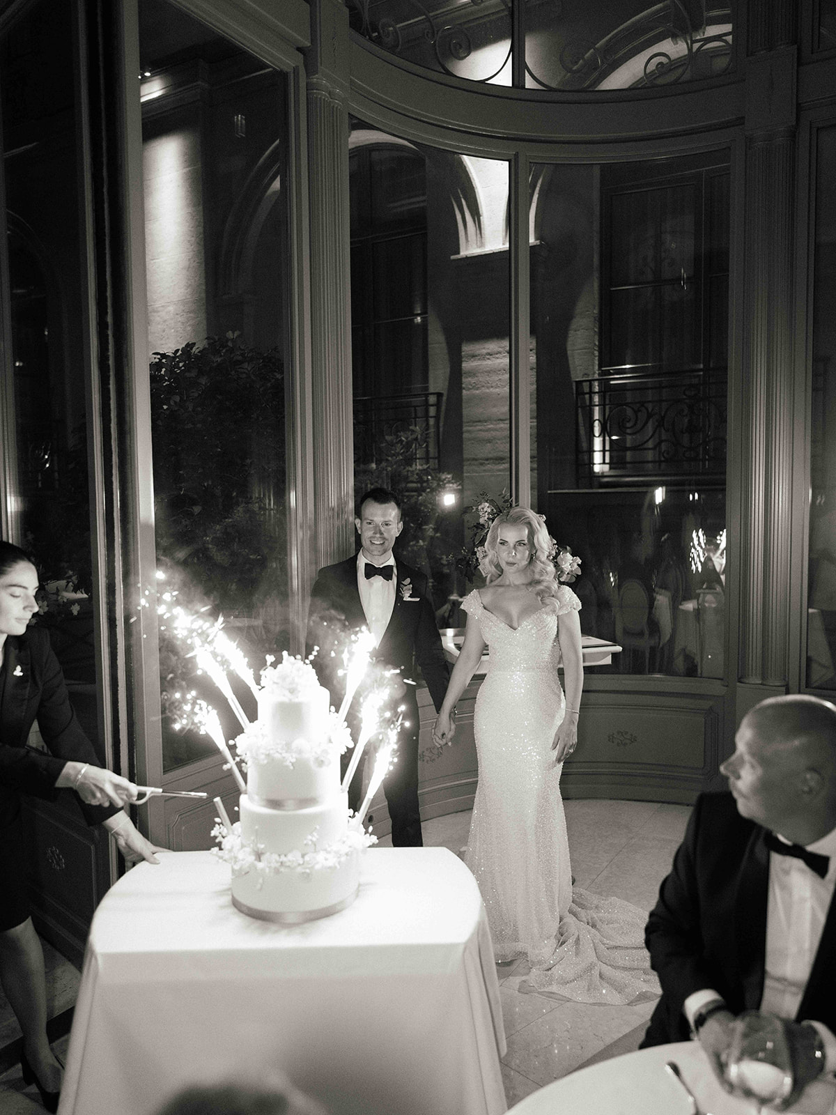 Black and white photograph of the wedding cake celebration at The Ritz Paris